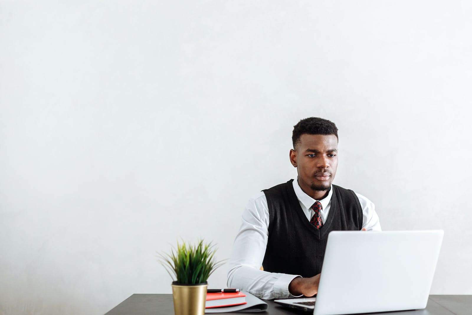 A Man Using a Laptop in the Office