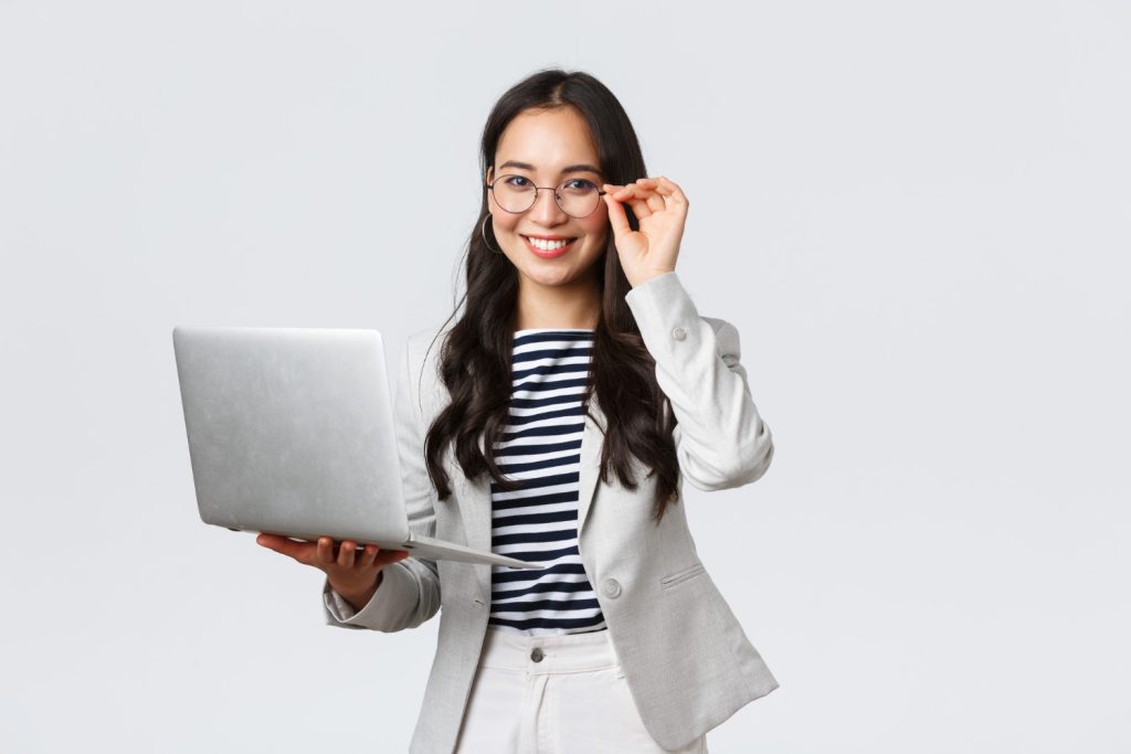 business finance employment female successful entrepreneurs concept confident smiling asian businesswoman office worker white suit glasses using laptop help clients