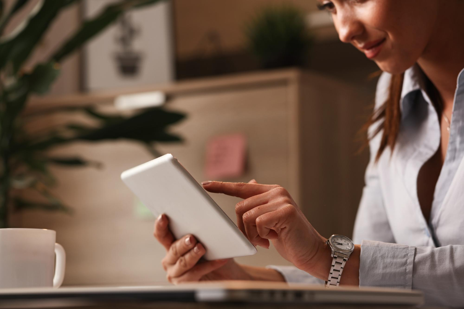 close up smiling businesswoman browsing internet touchpad work