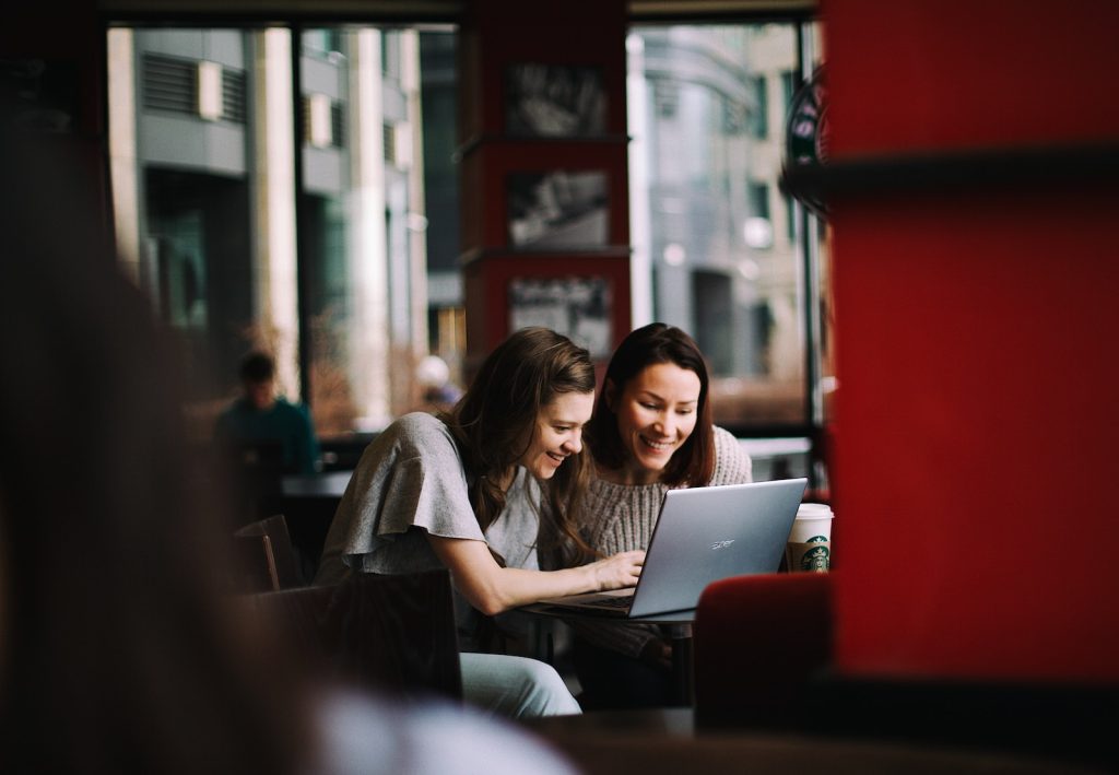 LinkedIn InMail woman in white shirt using macbook