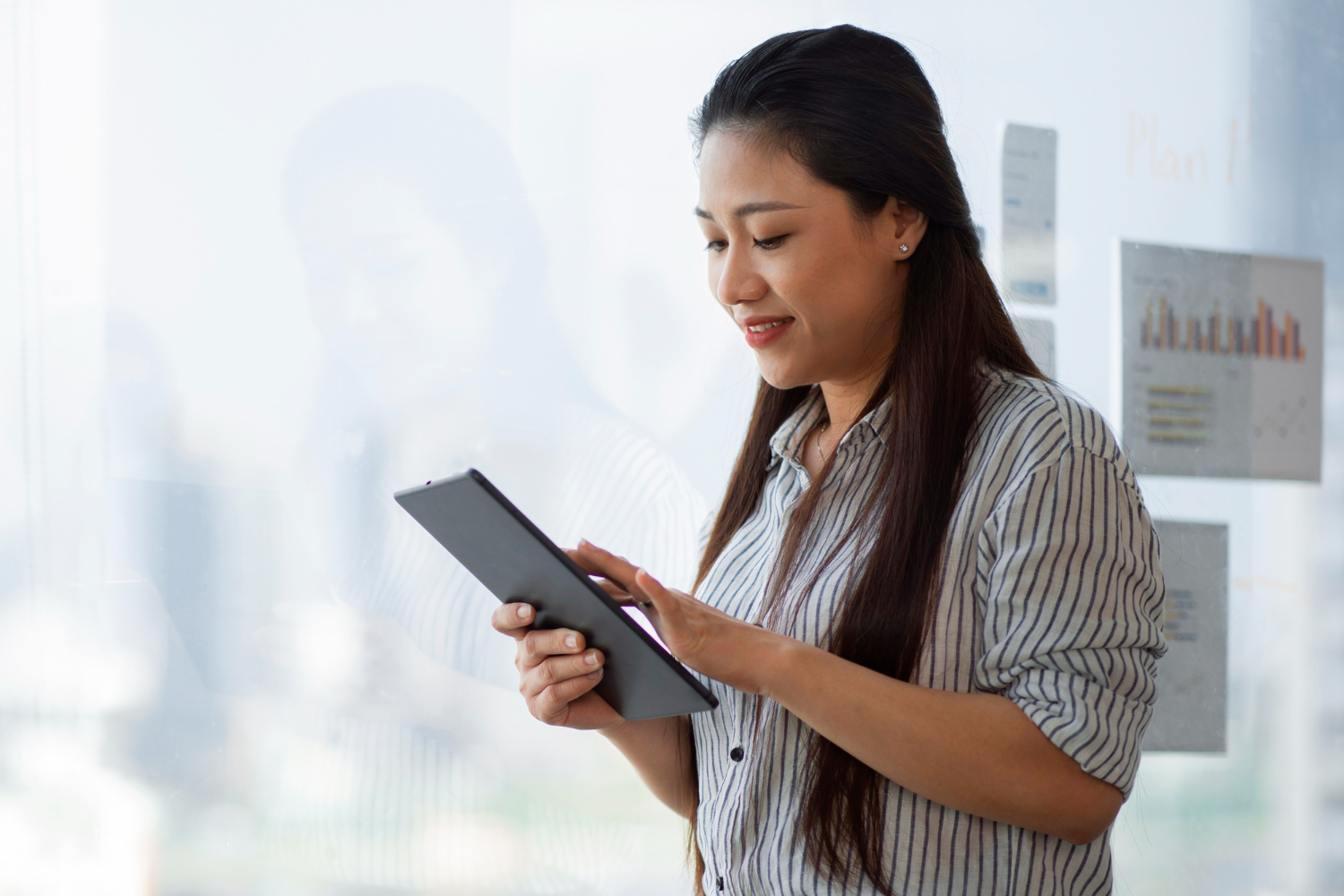 side view smiley woman holding tablet