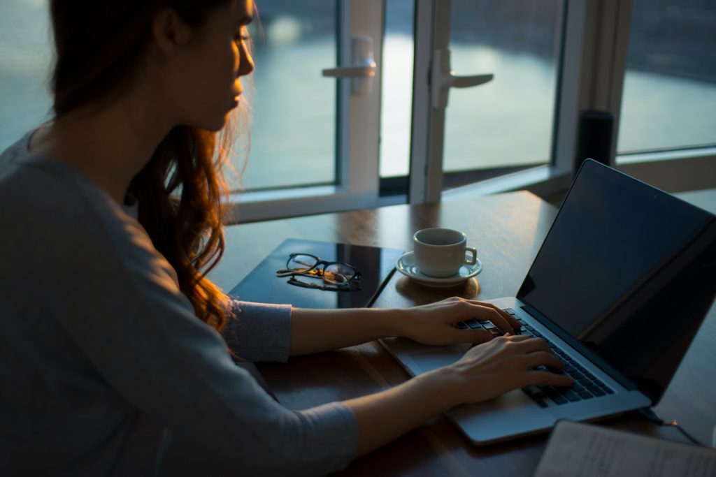 Apple At Home Advisor Review woman sitting beside table using laptop
