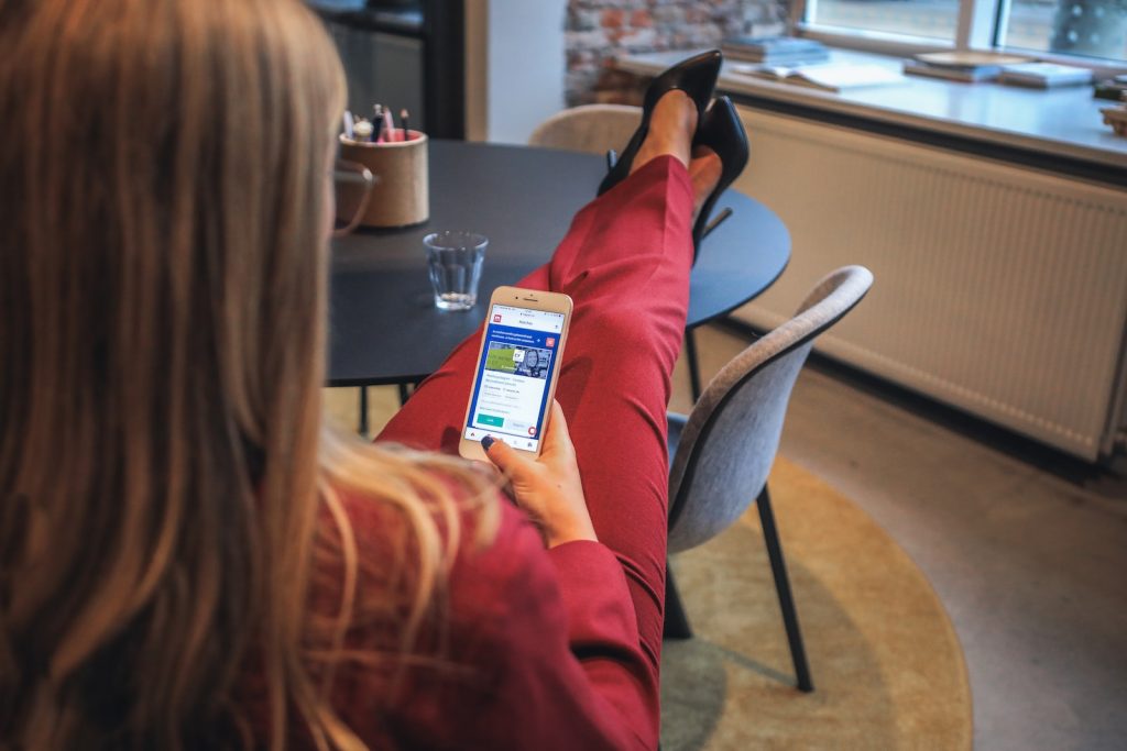 The Ultimate Viggle App Review: Earn Money Watching TV or a Time-Wasting Scam? 3 woman in red jacket holding white smartphone