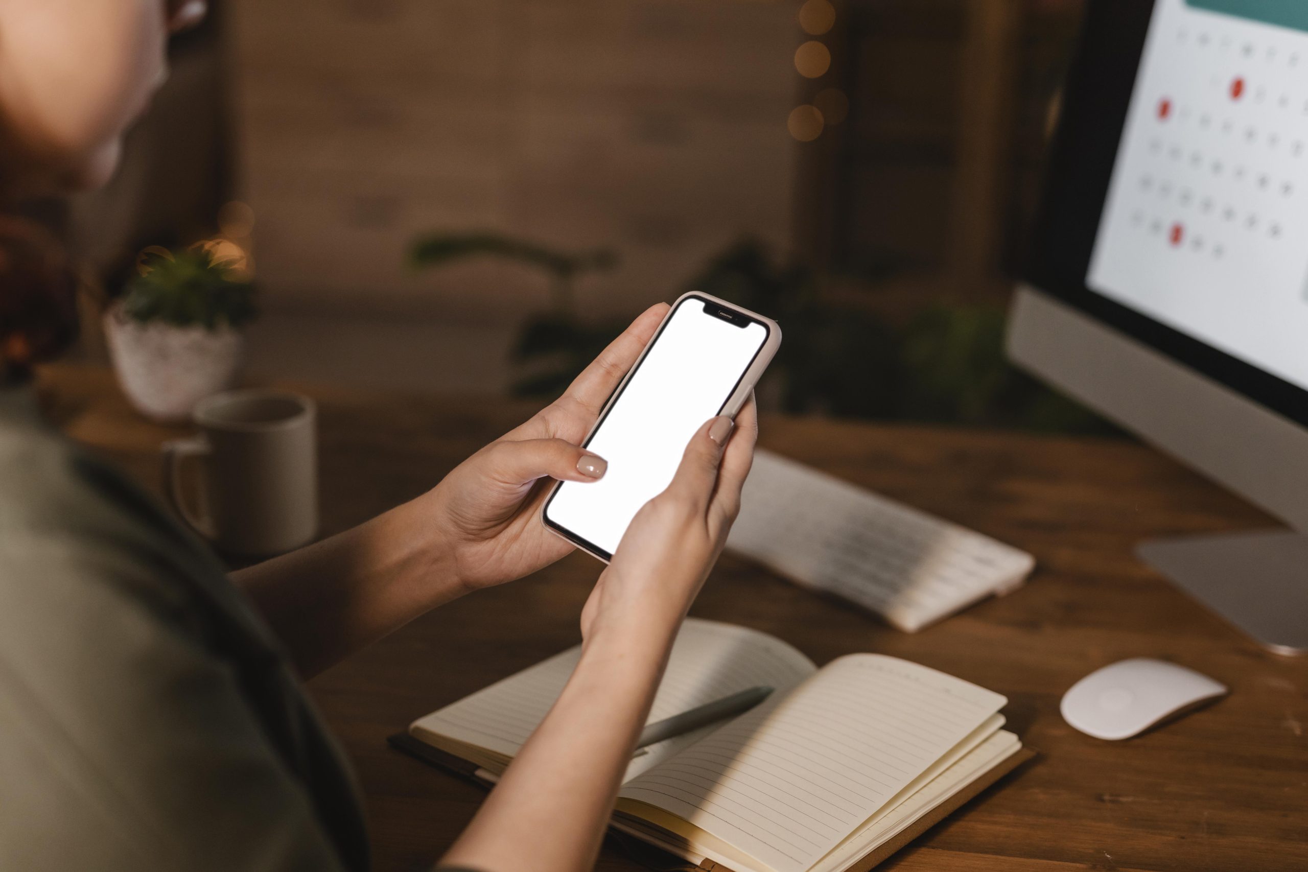 side view woman home using her smartphone front her computer